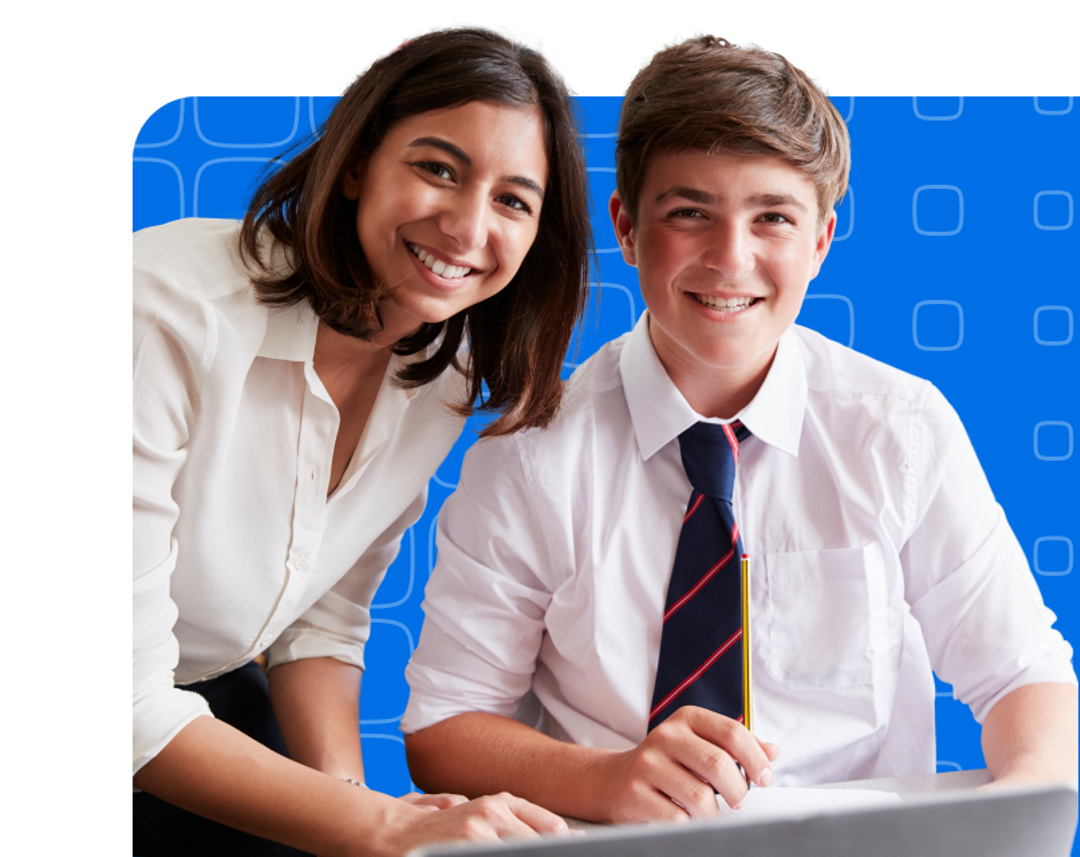 A teacher and a school boy sitting at a desk