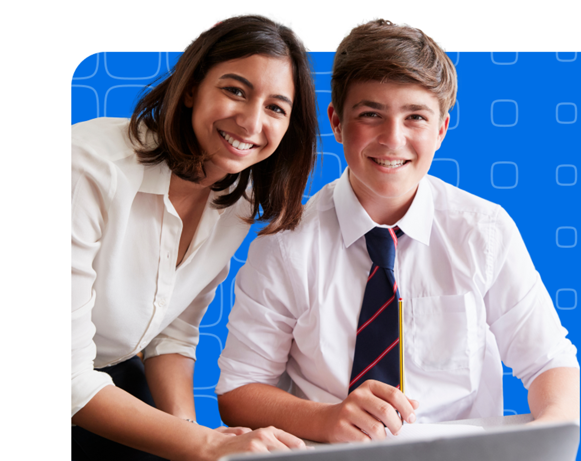 A teacher and a school boy sitting at a desk
