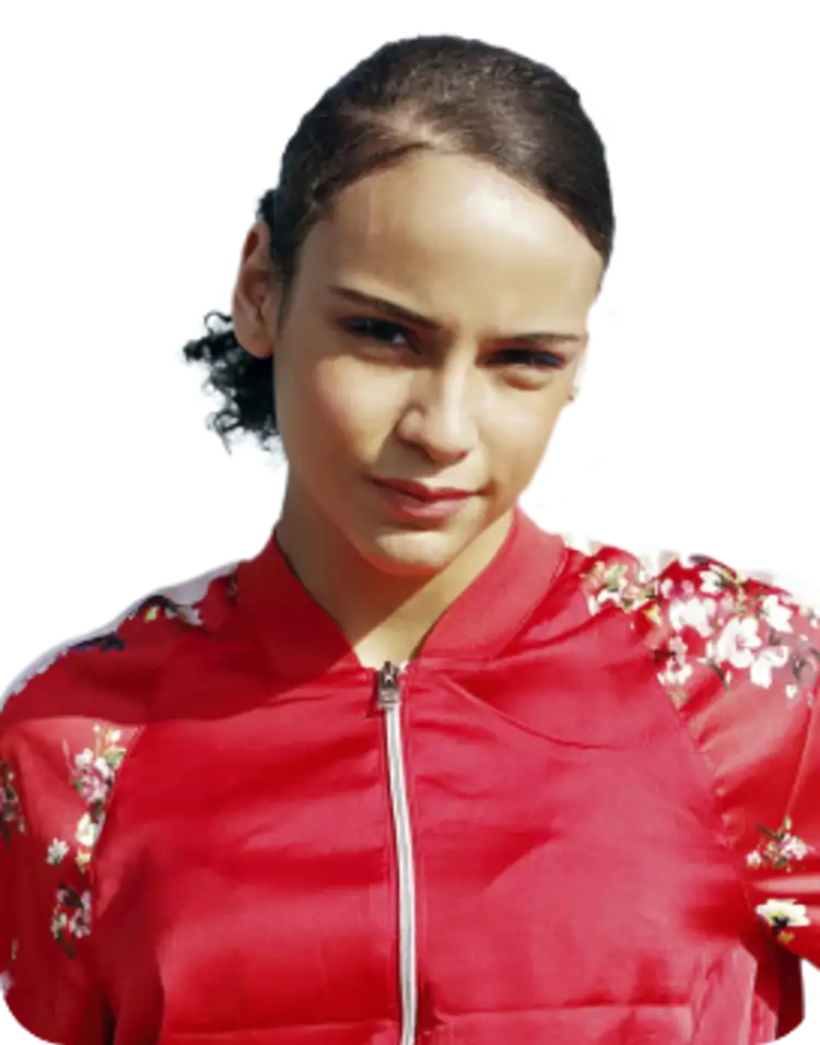 Young girl wearing a red top with flowers down the sleeves