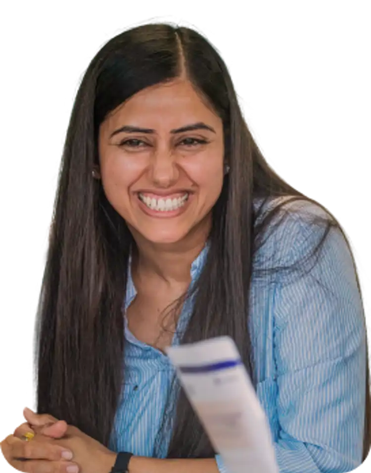 A teacher sits smiling with others