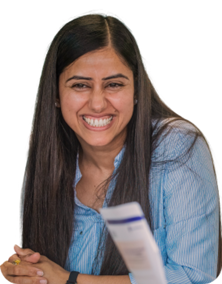 A teacher sits smiling with others