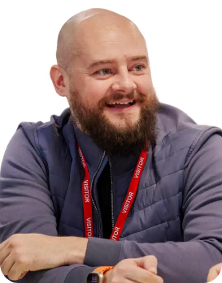 A community partner sits smiling with others