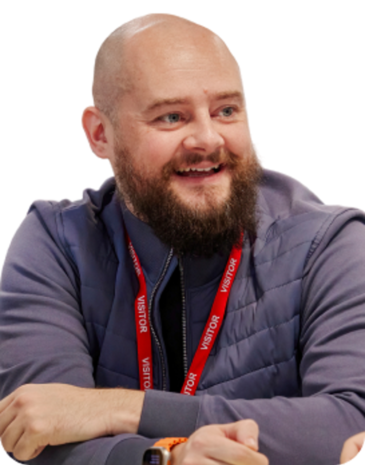 A community partner sits smiling with others