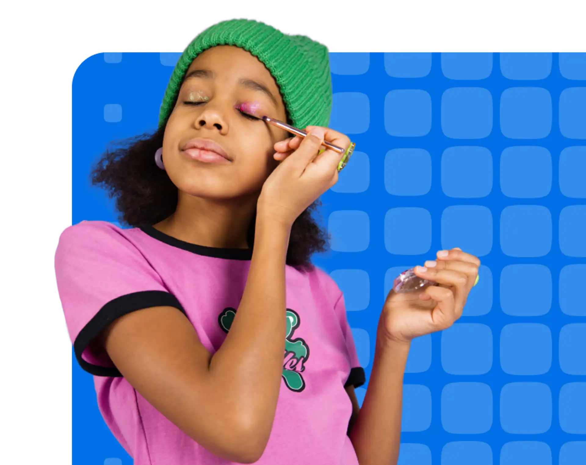 Young girl putting eye shadow on