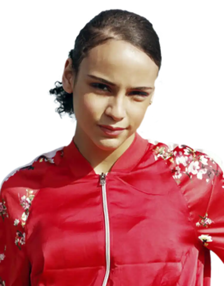 Young girl wearing a red top with flowers down the sleeves